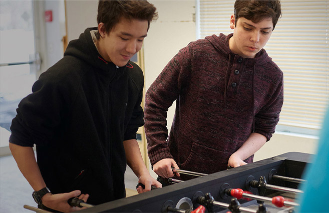 Woodhouse Academy Student Community Life Playing Foosball
